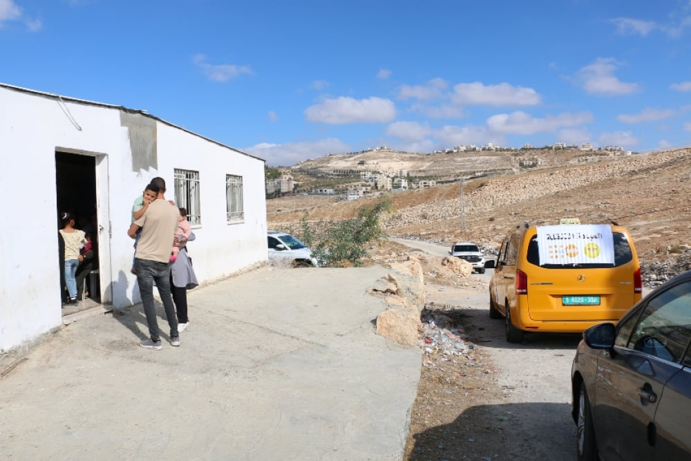 A family arrives at the clinic to receive healthcare services from the mobile health team during their visit to Al Uqban village in Bethlehem’s Area C in the West Bank.