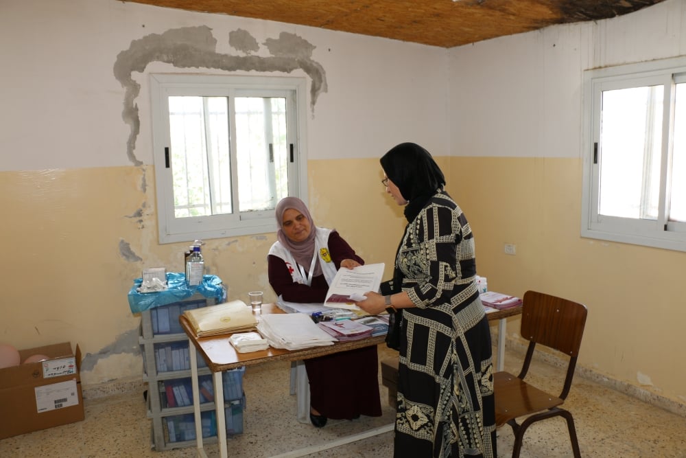 A PMRS staff member, part of the mobile health care team, works in the clinic in the Al Uqban village in Bethlehem’s Area C in the West Bank.