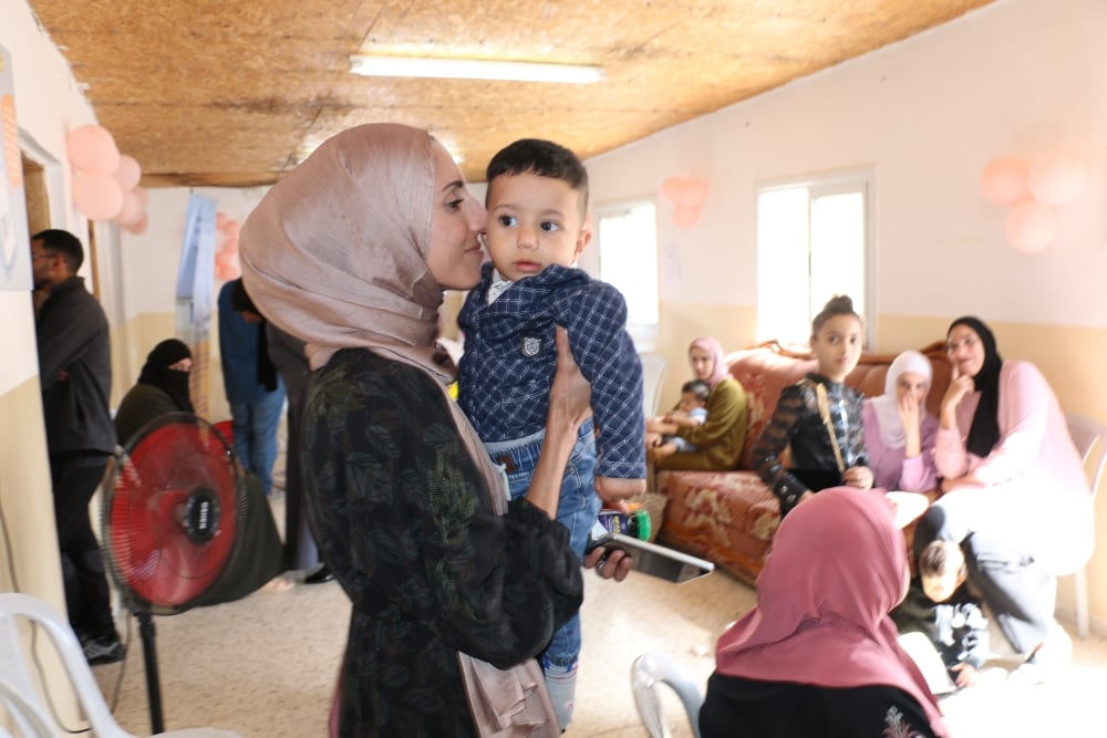 Duaa, 31, nuzzles her young son while waiting for her turn to receive health care services from the mobile health care team at Bethlehem’s Al Uqban village in West Bank’s Area C