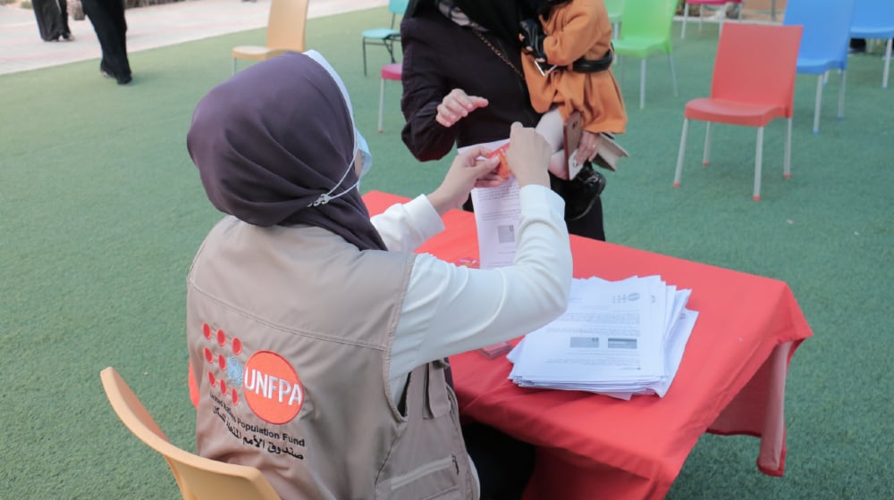 UNFPA staff distributing CVA to women survivors of violence