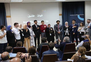 Standing in respect to the YAP Anthem during YAP launching ceremony in Bethlehem