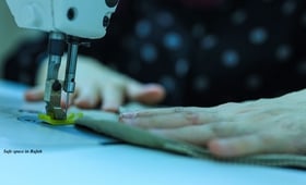 Woman in Safe Space in Rafah, learning sewing