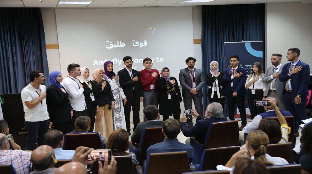 Standing in respect to the YAP Anthem during YAP launching ceremony in Bethlehem